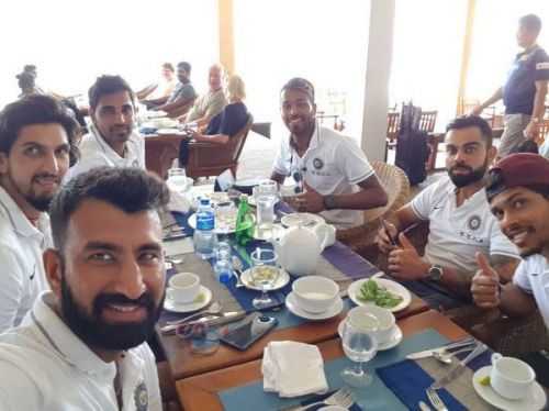 Indian cricket team posing at the lunch table