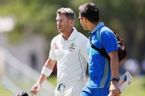 Warner walks off the field after getting hit on the head