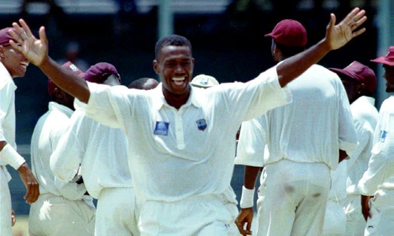 Ian Bishop celebrates the fall of a wicket