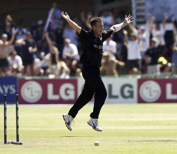 Shane Bond of New Zealand celebrates taking the wicket of Ian Harvey of Australia to finish with figures of 6 for 23