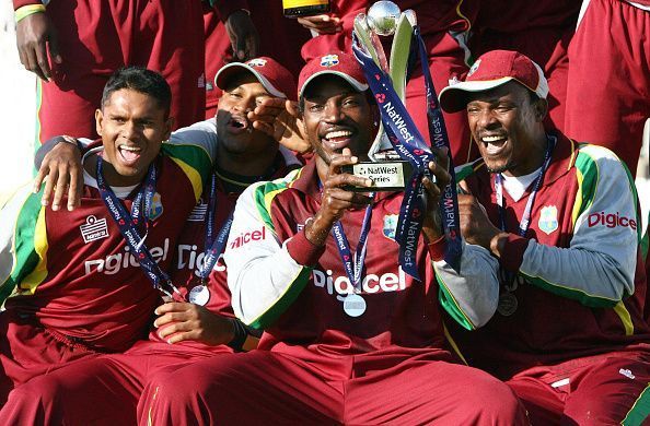Gayle celebrates with his teammates after clinching the trophy
