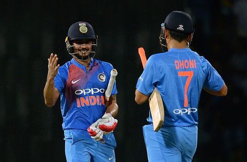 Pandey and Dhoni celebrate the winning runs