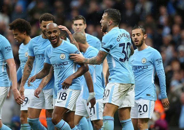 The Manchester City players celebrate scoring a goal