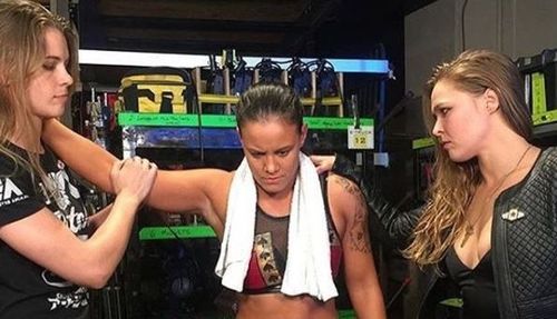 Shayna Baszler (Center) is a close friend of former UFC Champion Ronda Rousey (Right)