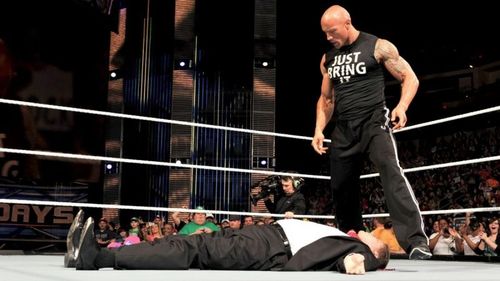 The Rock about to deliver a People's Elbow to John Laurinaitis