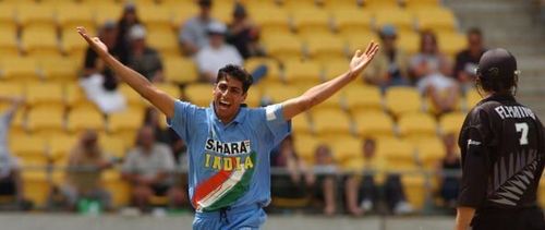 India's Asish Nehra celebrates his dismissal of Ne