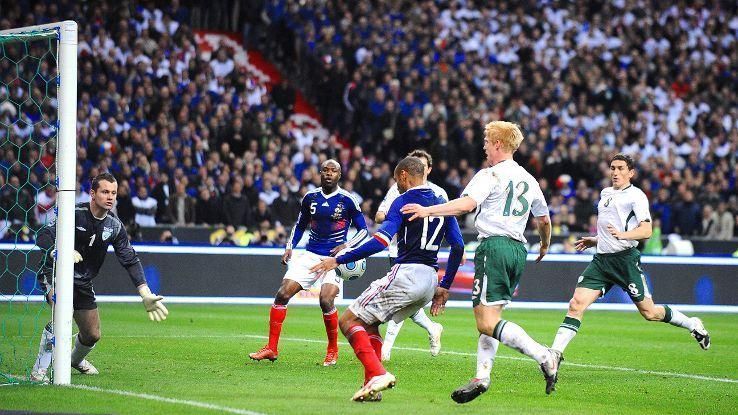 Theirry Henry handles the ball before setting up France's goal