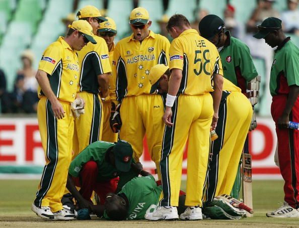 Kennedy Obuya of Kenya lies on the ground after being hit and bowled by Brett Lee of Australia