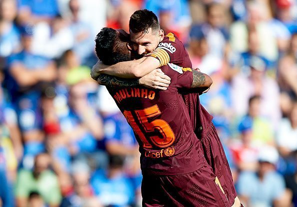Paulinho celebrates with Messi after scoring the winner against Getafe