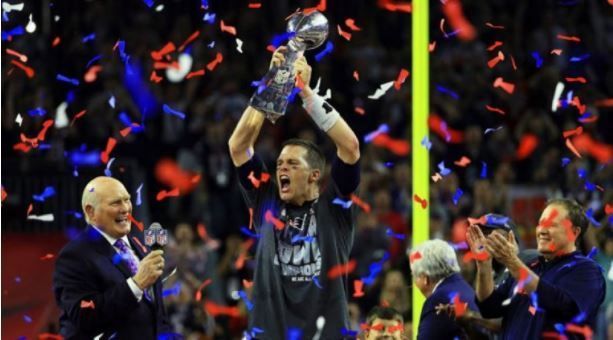 Tom Brady celebrating with the trophy after Super Bowl LI