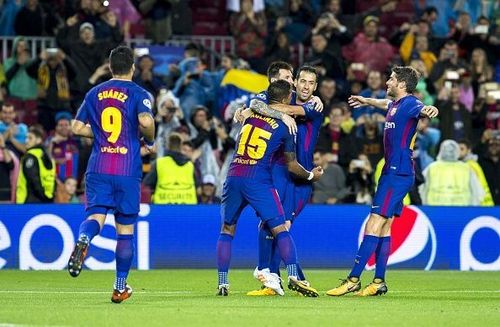 The Barcelona players celebrate scoring against Olympiakos