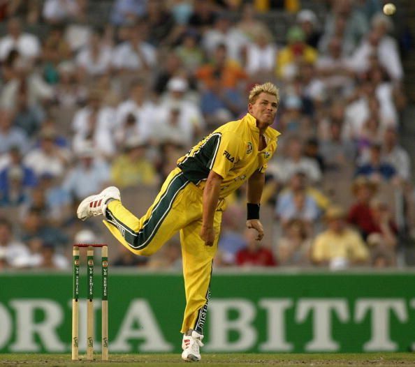 Shane Warne of Australia bowls
