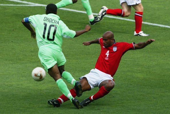 Jay-Jay Okocha of Nigeria is tackled by Trevor Sinclair of England
