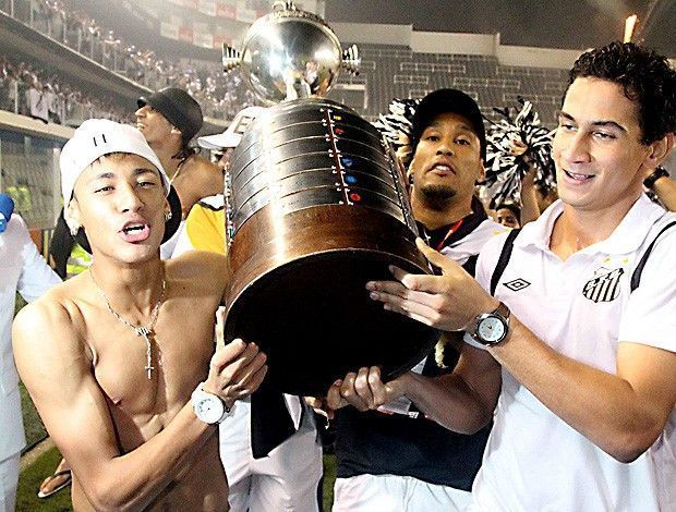 Neymar and Ganso lift the 2011 Libertadores trophy after guiding Santos to the title 