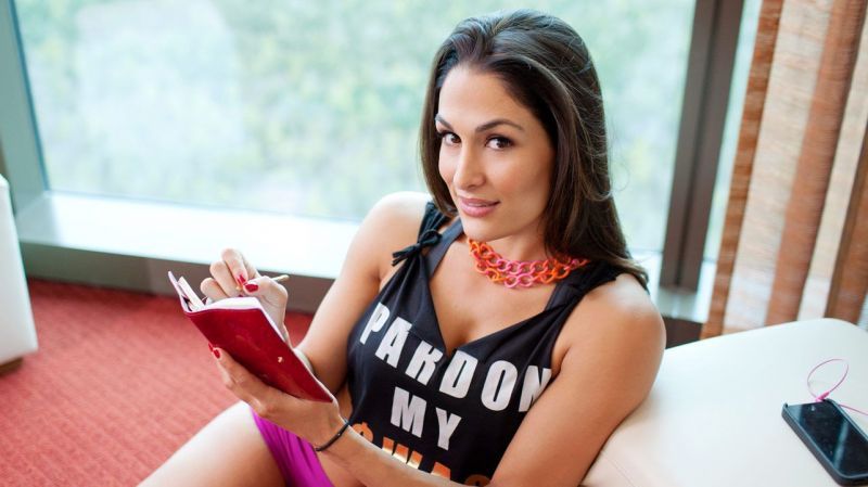 Nikki Bella with a notepad