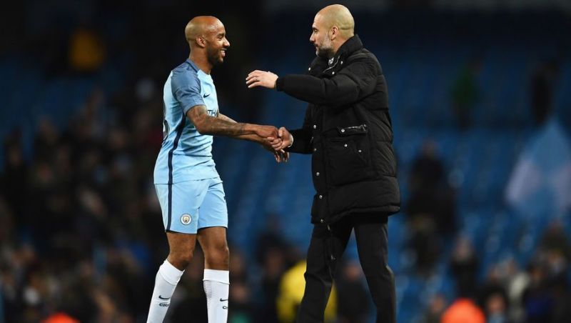 Guardiola congratulates Delph after a win.