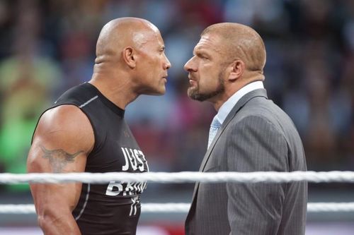 IMAGE DISTRIBUTED FOR WWE - Dwayne the Rock Johnson stares off against WWE superstar Triple H at WrestleMania 31 on Sunday, March 29, 2015 in Santa Clara, CA. WrestleMania broke the Leviâs Stadium attendance record at 76,976 fans from all 50 states and 40 countries. (Don Feria/AP Images for WWE)