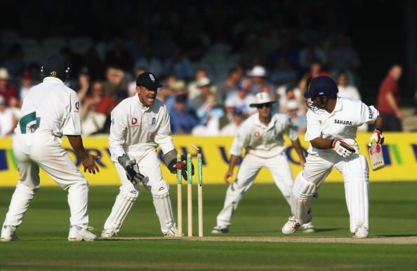 Virender Sehweg of India hits the ball back onto his wicket