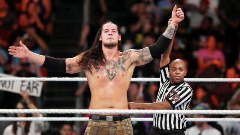 Baron Corbin having his hand raised in the ring