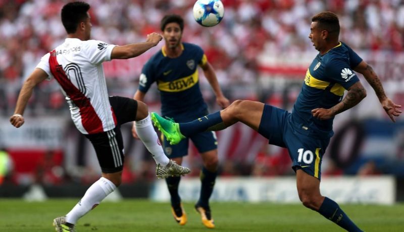 Players of River Plate (left) &amp; Boca Juniors (right) vie for the ball during a recent derby game