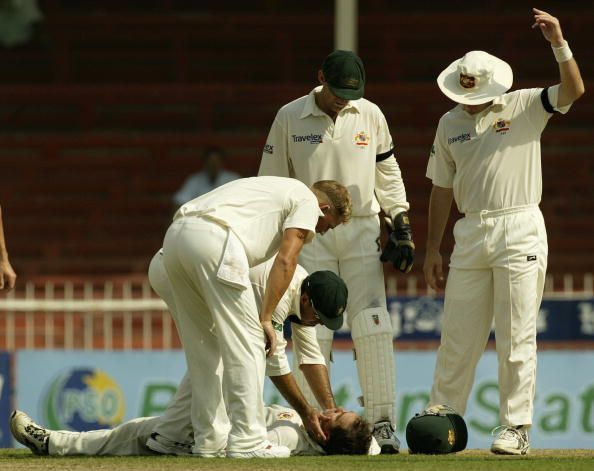 Justin Langer is hit by the ball