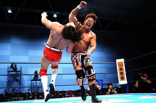 Satoshi Kojima connects his signature Lariat move on Juice Robinson 