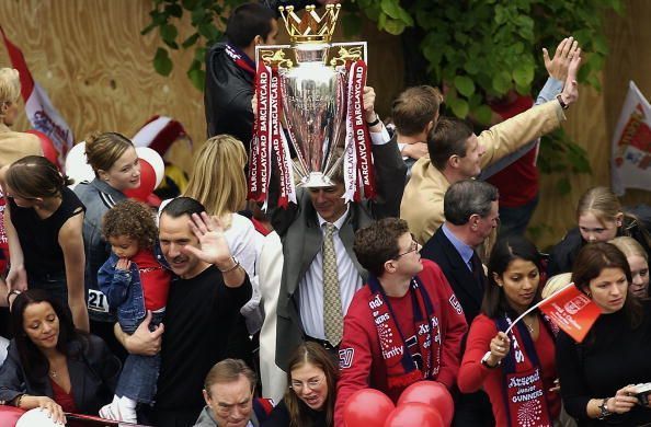 Arsenal manager Arsene Wenger lifting the FA Barclaycard Premiership trophy