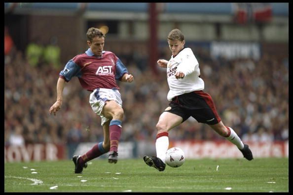 Gareth Southgate of Aston Villa (left) goes for the ball with Ole Gunnar Solksjaer