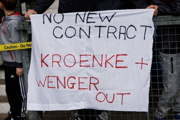 Arsenal fans with banners directed at owner Stan Kroenke and manager Arsene Wenger.