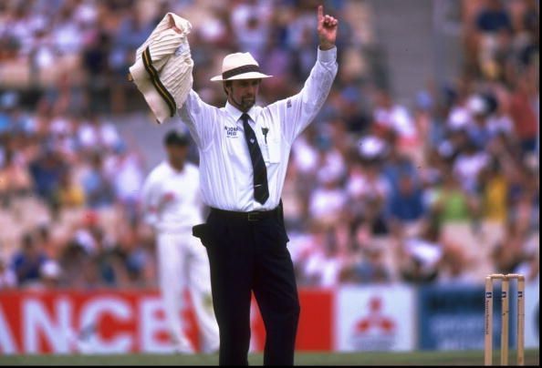 Umpire, Peter Willey of England signals six runs