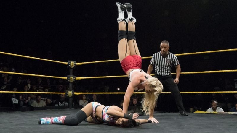 Lacey Evans about to drop her knees onto Dakota Kai