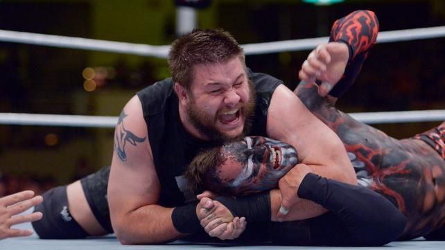 Kevin Owens taunts the Tokyo crowd as he takes Finn Balor to Chinlock City.