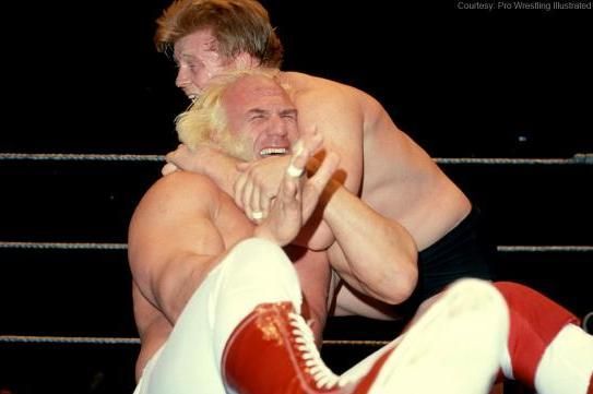 Superstar Billy Graham struggles to escape a chin lock.