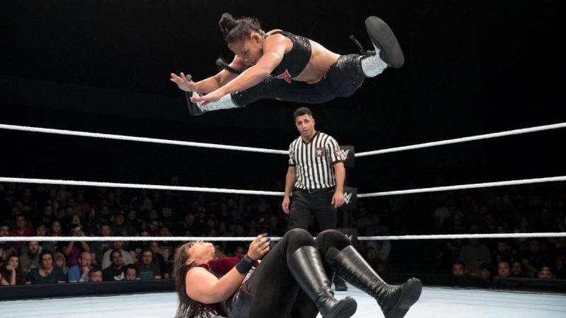 Bianca Belair performing the splits midair