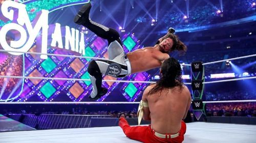 AJ Styles comes in to deliver a blow in his match against Shinsuke Nakamura