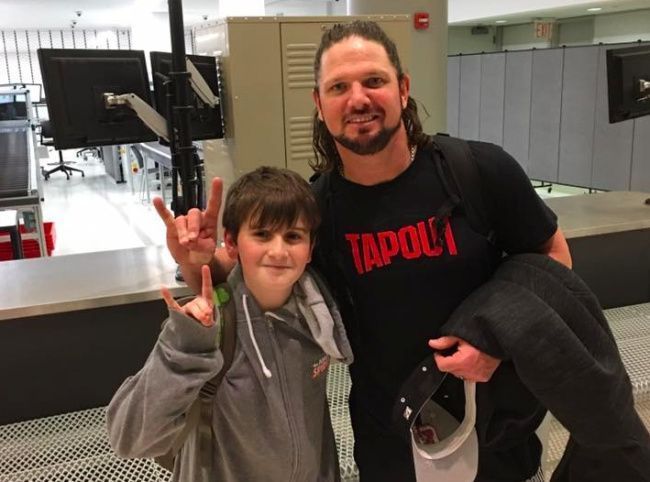 AJ Styles and a young fan.