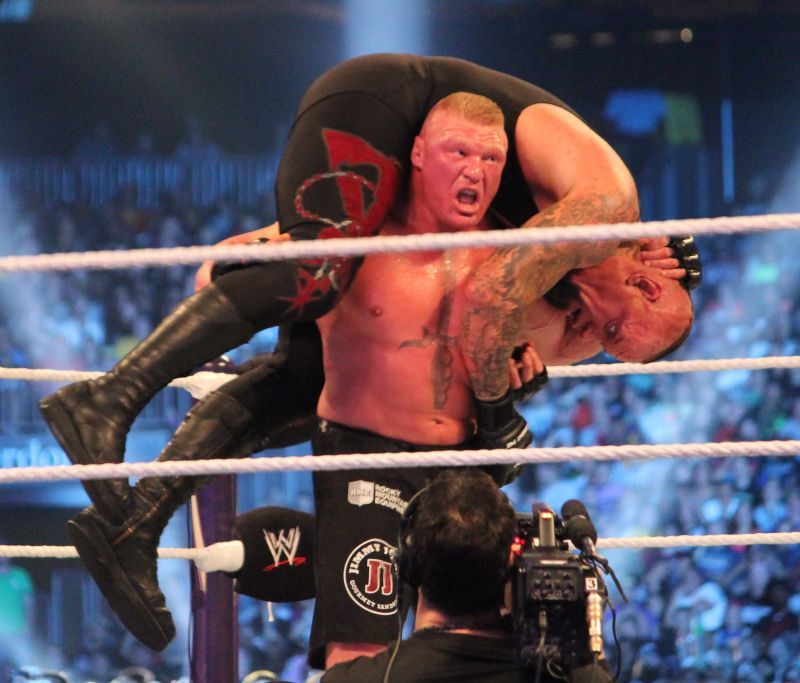 Brock Lesnar about to deliver an F-5 to The Undertaker.