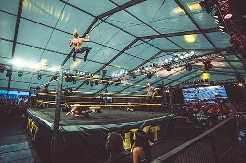 Mark Andrews performs a shooting star press at an NXT event during the UK's Download Festival