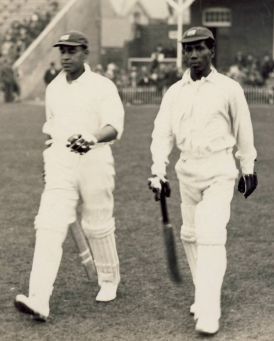 Clifford Roach (Right) walks out to open the innings in West Indies&#039; maiden Test