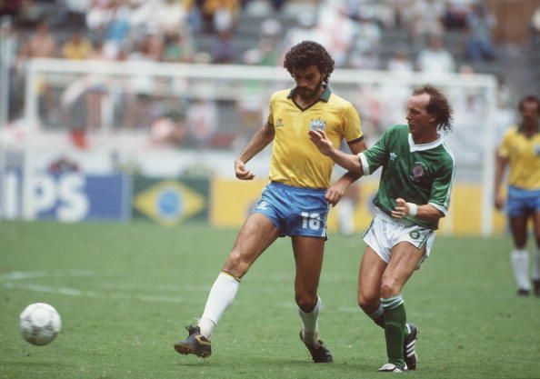 1986 World Cup Finals. Guadalajara, Mexico. 12th June, 1986. Brazil 3 v Northern Ireland 0. Brazil&#039;s Socrates is challenged for the ball by Northern Ireland&#039;s David McCreery.