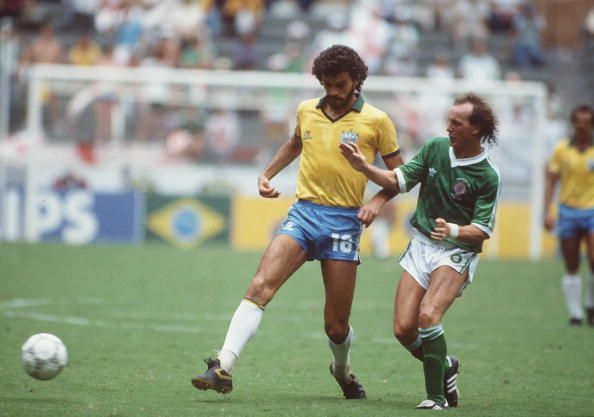 1986 World Cup Finals. Guadalajara, Mexico. 12th June, 1986. Brazil 3 v Northern Ireland 0. Brazil's Socrates is challenged for the ball by Northern Ireland's David McCreery.