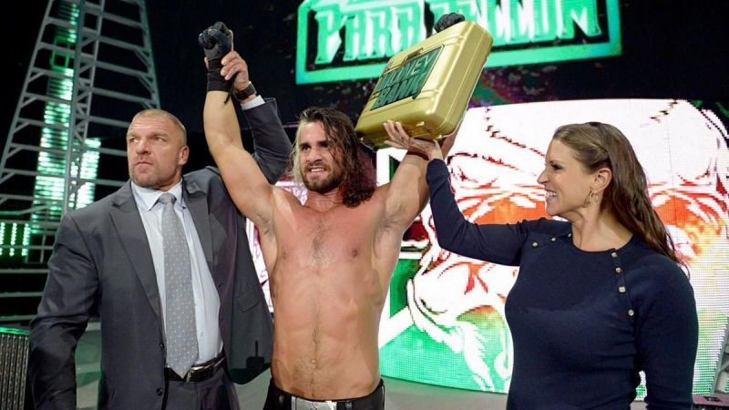 Seth Rollins, Triple H and Stephanie McMahon celebrate