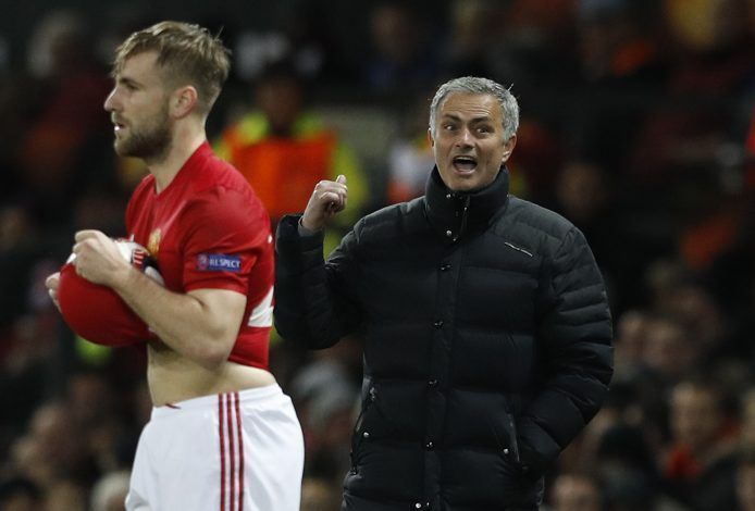 Luke Shaw prepares to throw as Mourinho looks on