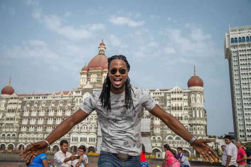 Omari Banks posing in front of the Taj Hotel in Mumbai