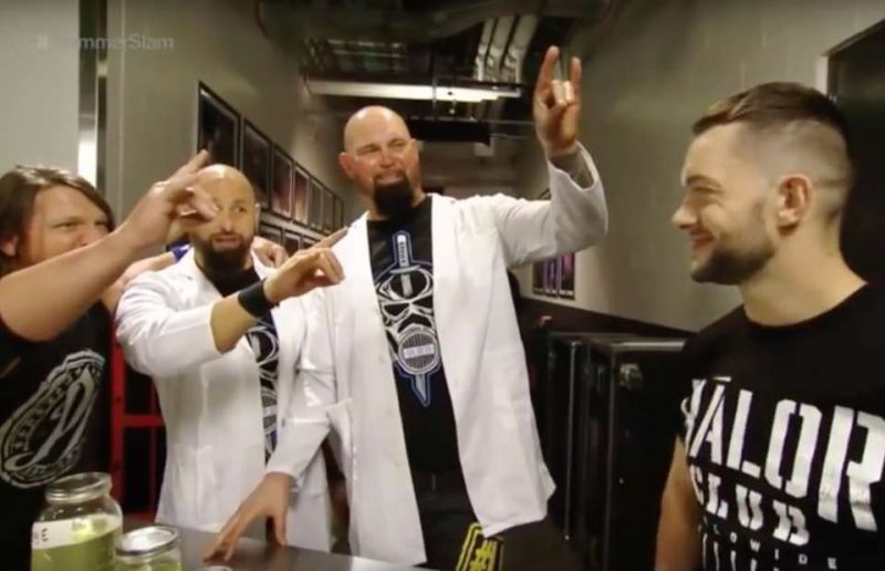 AJ Styles, Karl Anderson, and Luke Gallows offering a Too Sweet to Finn Balor at SummerSlam, 2016