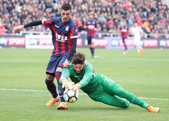 Roma&#039;s Brazilian goalkeeper Alisson (R) makes a save against...