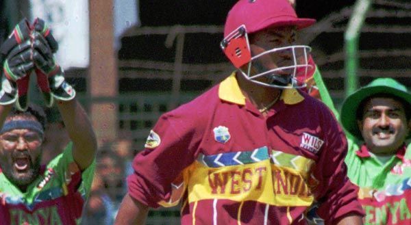 Brian Lara walks back after being dismissed. 