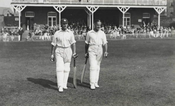 Cricket. Circa 1930+s. A picture of the legendary England batting pair of JB (John &#039;Jack&#039; Berry) Hobbs (Surrey) and Herbert Sutcliffe (Yorkshire) walking out to bat at the Scarborough Cricket Festival.