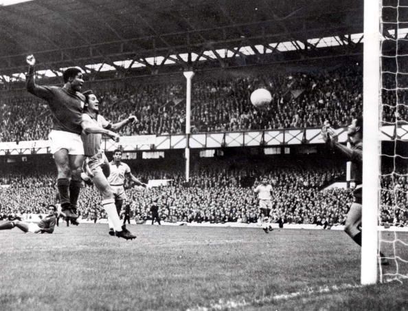 World Cup Finals, 1966. Liverpool, England. 19th July, 1966. Portugal 3 v Brazil 1. Eusebio of Portugal (L) beats Brazil's Orlando to the ball to head home his side's second goal past Brazilian goalkeeper Manga during their Group Three match