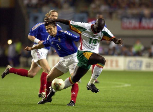 BT Football. FIFA World Cup Finals. Korea. Seoul. 31st May 2002. France 0 v Senegal 1. Senegal&#039;s Moussa Ndiaye passes Bixente of France.